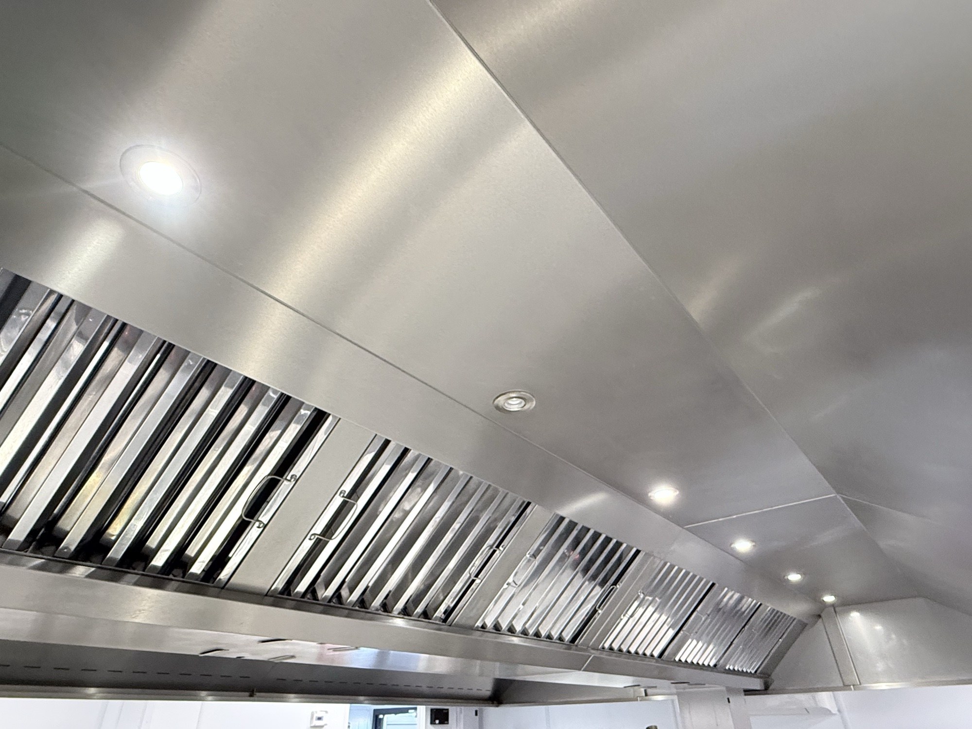 Stainless steel commercial kitchen extraction canopy after a TR19 clean