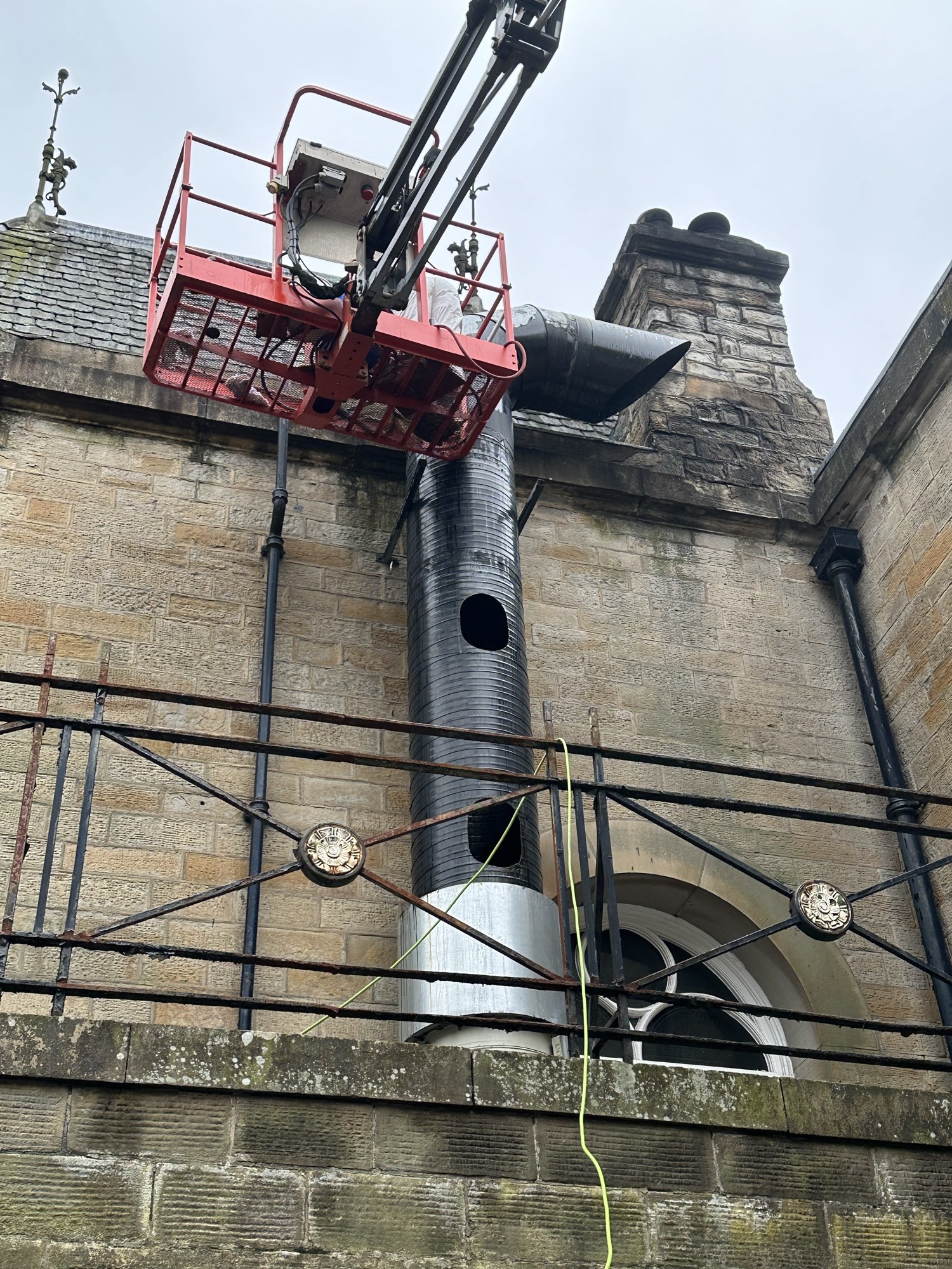 Waring FM operatives carrying out high level cleaning from a cherry picker on a historic building